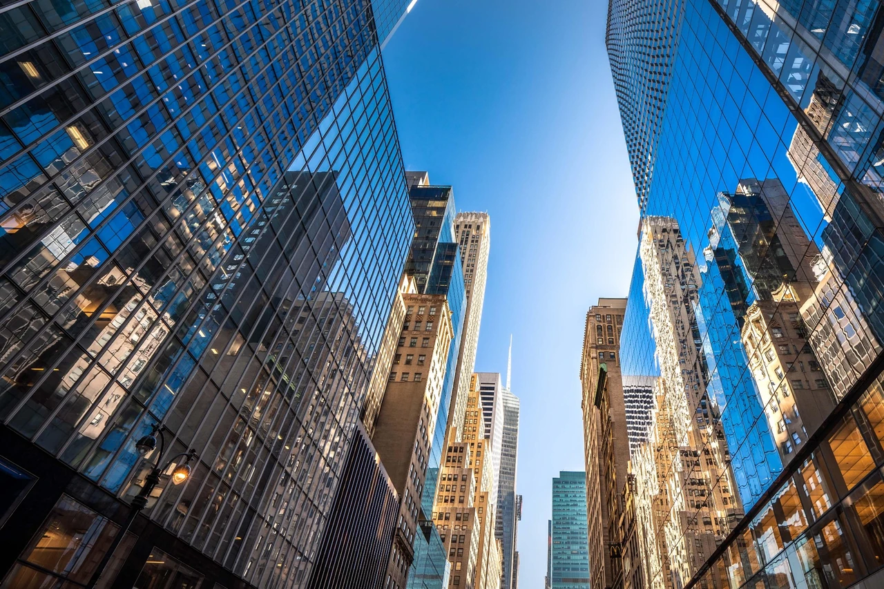 Reflective glass towers framing a clear blue sky
